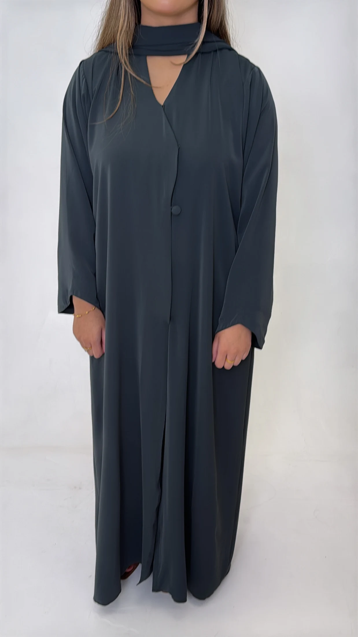 Front view of a plain teal abaya with covered buttons.