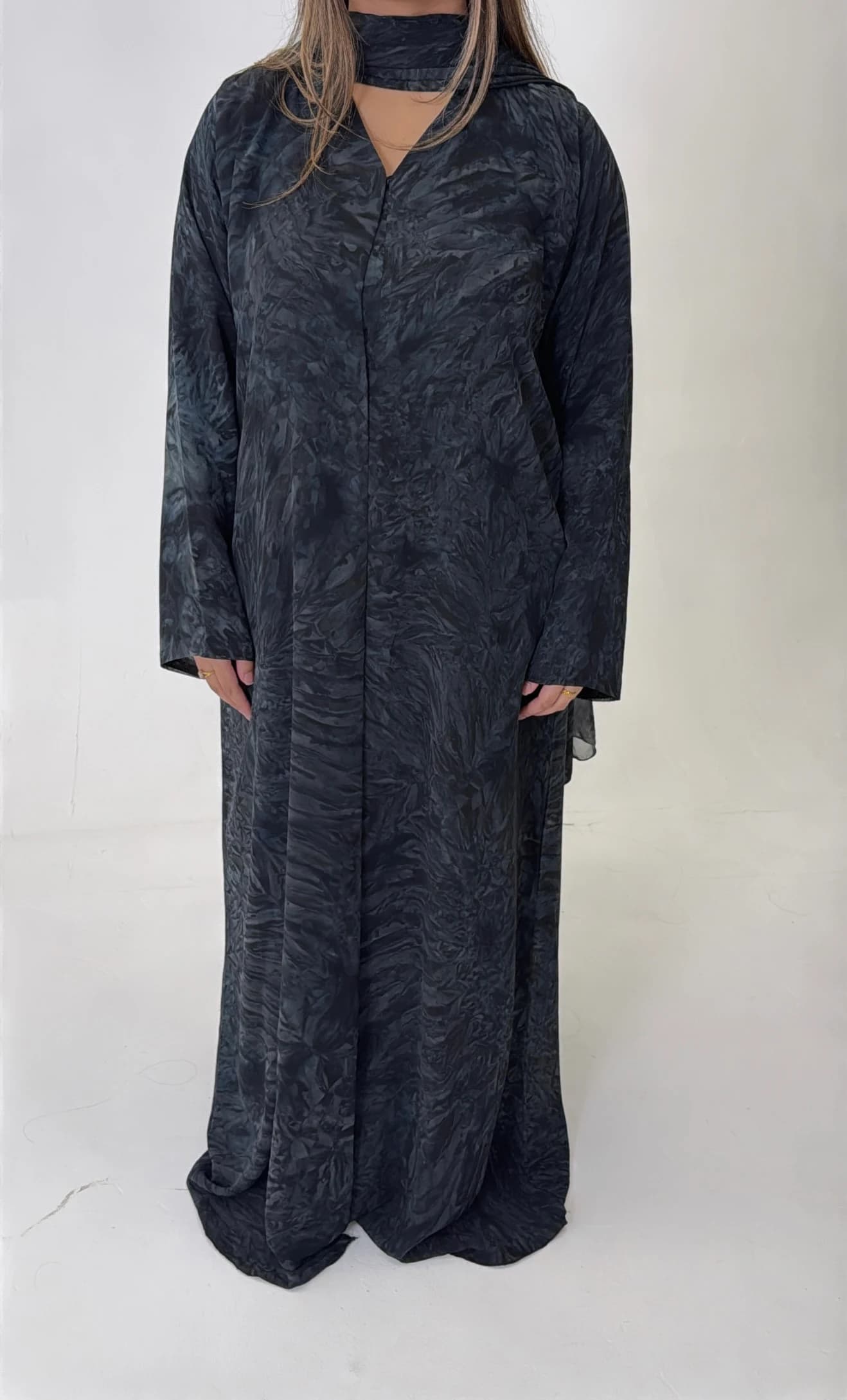 Blue tie-dye abaya with a flowing shape and wide sleeves.