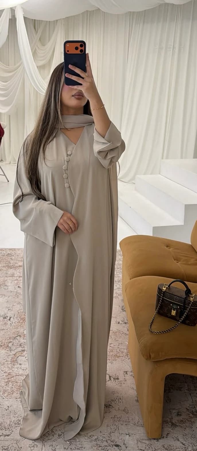 Full-length mirror photograph of a cream abaya and scarf.